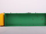 an image of a green and yellow box sitting on top of a white surface