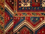 a close up of a red, blue, and yellow oriental rug