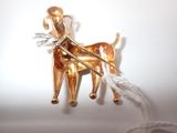 a gold figurine of a dog pulling a sleigh