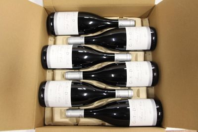 six bottles of wine in a box on the table