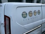 a white van with four round windows on the side of it