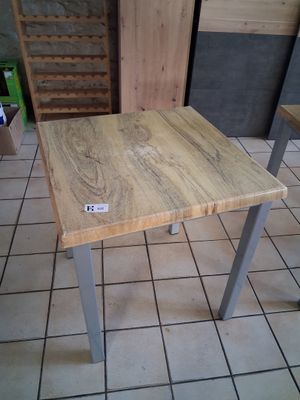 a wooden table with a tag on it in a room