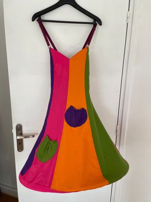 a colorful dress hanging on a hanger in front of a door