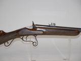 an old gun with a wooden barrel and a metal handle