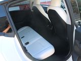 a white car with two black seats in the back of it