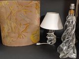 a lamp that is next to a glass bottle and a lamp shade