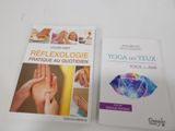 two books about yoga and reflexology on a white table