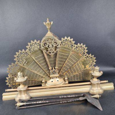 an antique brass fan with a wooden stand and a knife
