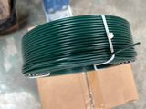 a spool of green wire on a carton
