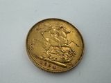 a close up of a gold coin on a white surface