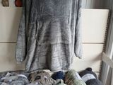 a pile of yarn on a table with a sweater on it