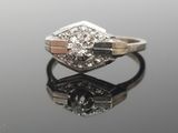 an image of a diamond ring on a reflective surface
