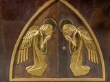 two golden angels on the door of a building