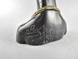an image of a statue of a foot with a ring on it