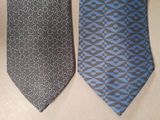 two ties that are on a table next to each other