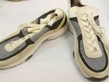 pair of sneakers with laces on top of them sitting on a table