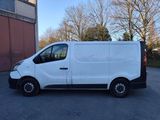 a white van parked in a parking lot next to a building