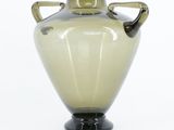 a glass vase with two handles on a white background