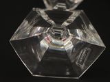 a clear glass object on a black surface