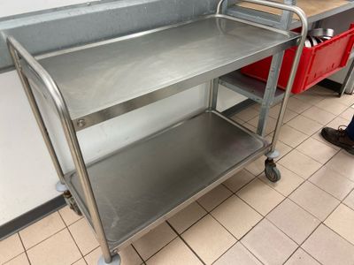a metal cart with a handle on it in a kitchen