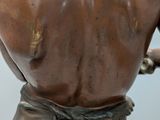 bronze statue of a woman with a flower in her hair