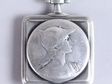 a silver coin with a woman ' s face on it