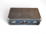 an old suitcase with a checkered pattern on it