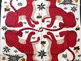 a red and black scarf with leopards and flowers on it