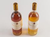 two bottles of wine sitting next to each other on a table