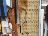 a painting of a violin and music notes on a table