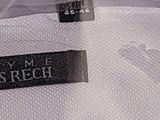 a close up of a white shirt with a black label on it