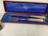 a silverware set in a red case on a white surface