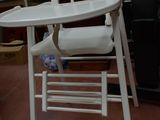a white high chair that is sitting in a room