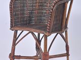 a wicker chair that is sitting on a white surface
