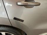 a close up of a car door handle with a sticker on it