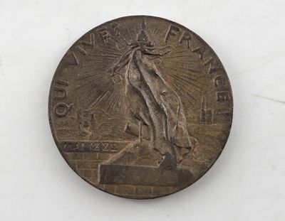 an old coin with a statue on it sitting on a white surface