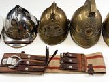 four different types of helmets and a knife on a table