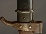 a close up of a metal object on top of a wooden pole