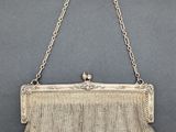 an antique silver mesh purse with a chain handle