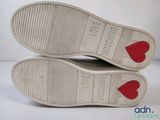 two pairs of white shoes with red hearts on them