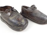 pair of old worn shoes on a white background