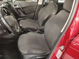 the interior of a red car with black seats and a steering wheel