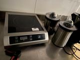 stainless steel counter top with a stove and coffee maker on it