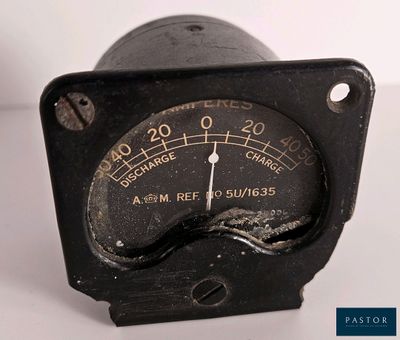 a close up of a black analog meter on a white surface