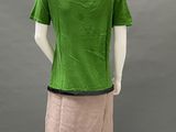 the back view of a mannequin wearing a green shirt and pink skirt