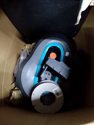 un aspirateur rangé dans une boîte en carton