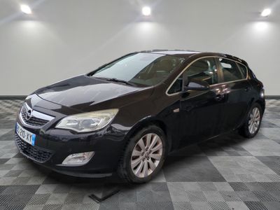 the black opel is parked on a checkered tile floor