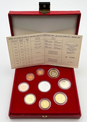 a red box containing six different coins and a ticket