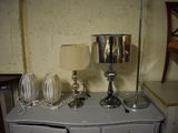a white dresser with two lamps on top of it