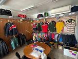 a room with a lot of clothes and a table